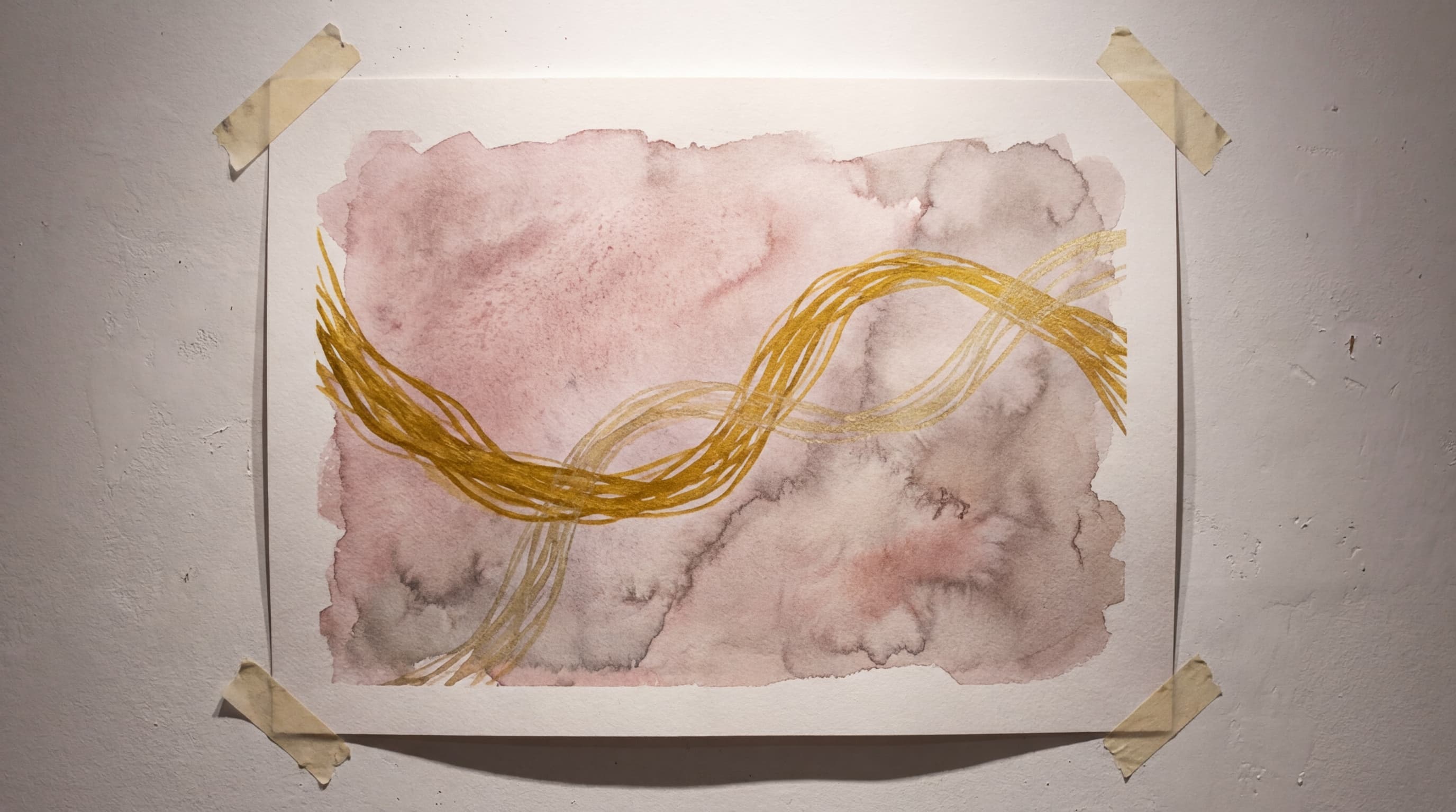 Watercolor painting of two golden threads intertwining against a soft rose wash