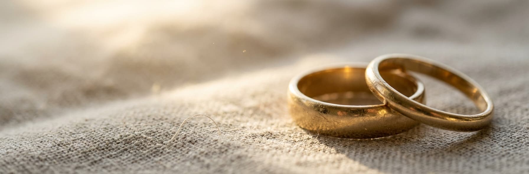 Soft watercolor of two hands almost touching with warm light between them