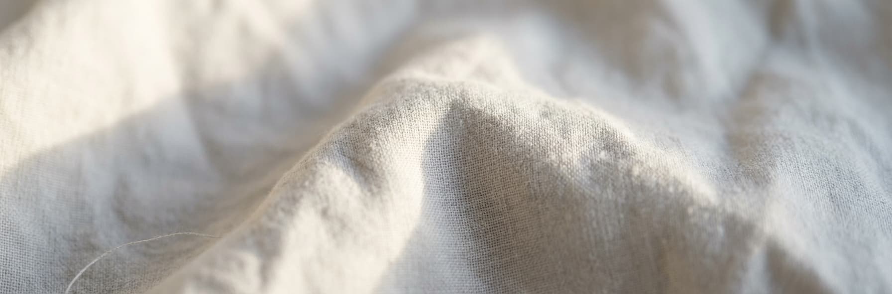 Soft linen fabric texture in cream and grey tones